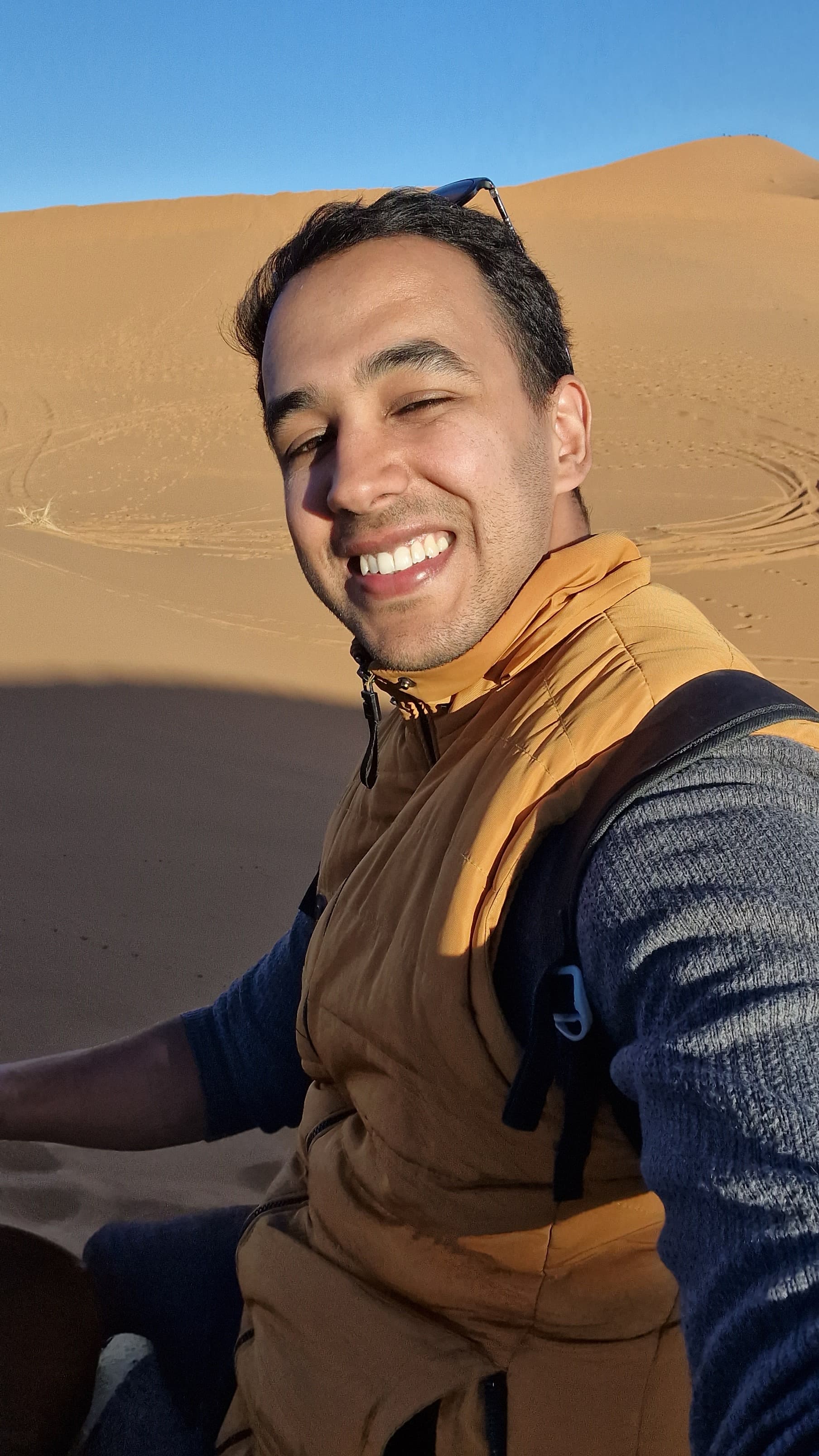 Morocco guide Mahmoud riding camel in Merzouga Sahara desert - authentic desert tour experience
